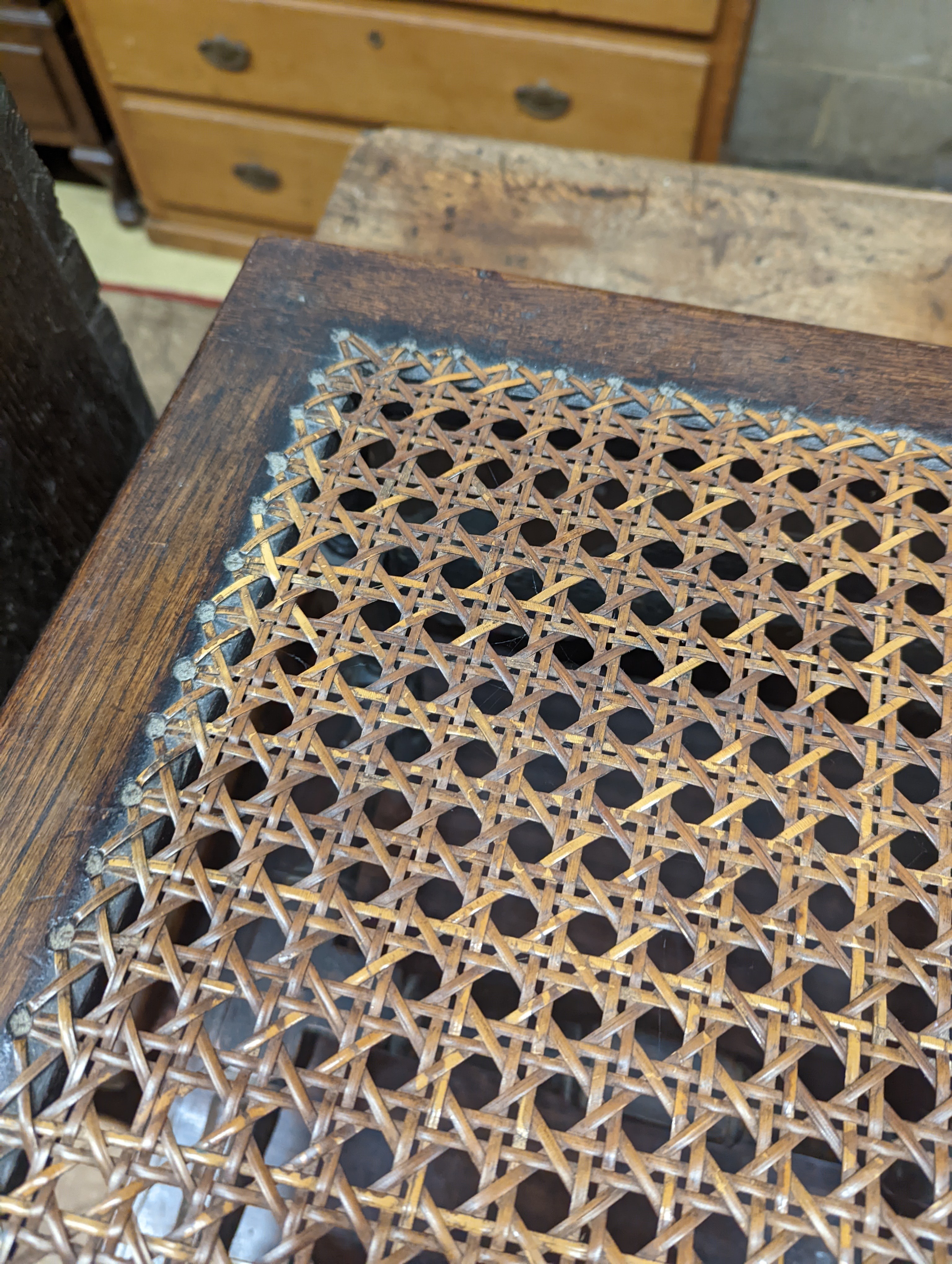 A 17th century style carved oak stool, with caned seat and H stretcher, width 47cm, depth 46cm, height 42cm